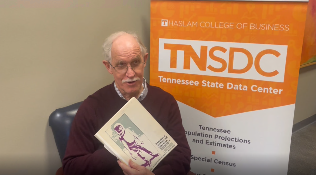 Gregg Robinson holds a copy of the 1972 population projections.